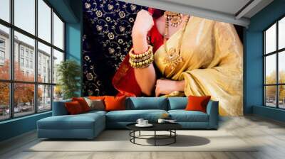 Indian Bridal wear in a golden and red saree and royal jewellry Wall mural