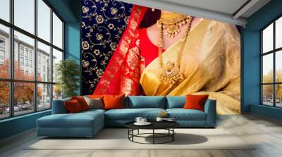 Indian Bridal wear in a golden and red saree and royal jewellry Wall mural