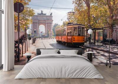 Famous vintage tram in the centre of the Old Town of Milan in the sunny day, Lombardia, Italy. Arch of Peace, or Arco della Pace on the background. Wall mural