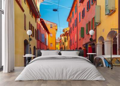 Medieval street portico with bright colored houses in the Old Town in the sunny day, Bologna, Emilia-Romagna, Italy Wall mural