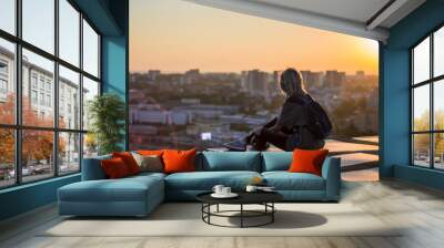 woman siting on the roof Wall mural