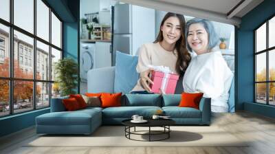 Asian beautiful woman daughter surprise her mother with birthday gift.  Wall mural