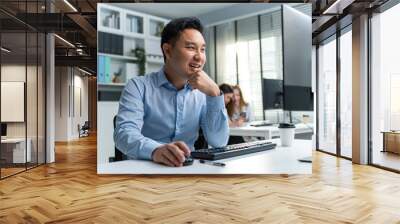 Asian handsome business man using laptop computer working in office.  Wall mural