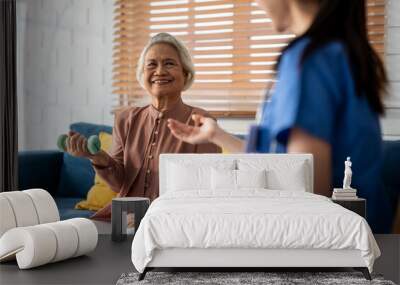 Asian senior elder woman doing physiotherapist with support from nurse. Wall mural