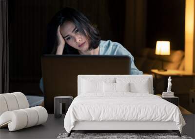 Asian woman work late from home in living room at late night overtime Wall mural