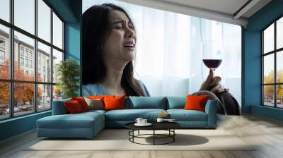 Asian young depression woman feeling heart broken and drinking wine. Wall mural