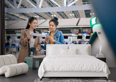 Asian young women passenger walk in airport terminal to boarding gate.  Wall mural