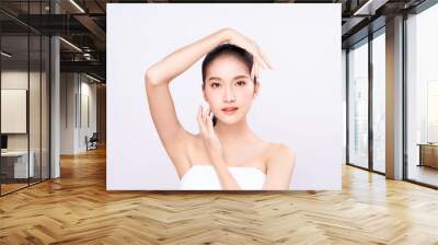 Beautiful Young Asian woman with clean fresh skin touching two hands on face in beauty pose. Pretty girl smiling in white background. Facial treatment, cosmetology, cosmetic surgery,  make up concept. Wall mural