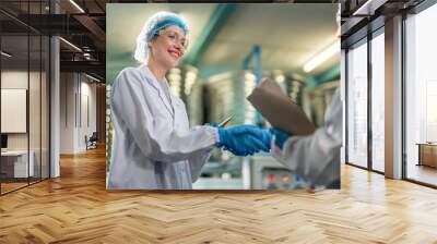 Caucasian female scientist working in laboratory at factory warehouse.  Wall mural