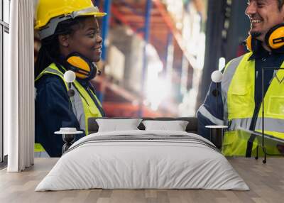 Close up of diverse industrial worker doing handshake in manufactory.  Wall mural