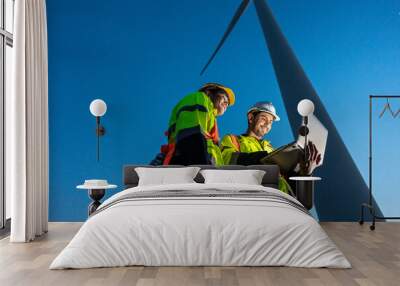 Diverse ethnicity male technicians working in the wind turbines field. Wall mural