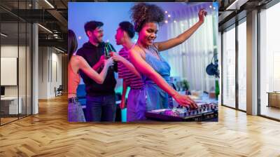 Group of diverse man and woman dancing with DJ mixing music on console.  Wall mural