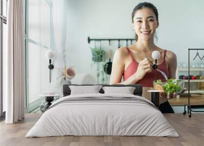 Portrait of Asian attractive woman hold salad bowl and look at camera.  Wall mural