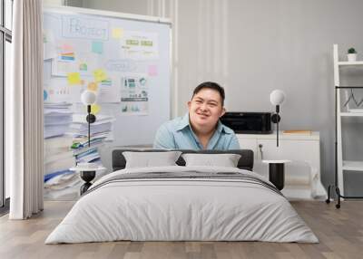 Portrait of Asian young businessman with down syndrome work in office.  Wall mural