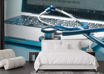 stethoscope, laptop on blue color background. Medical technology concept. Wall mural