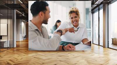 Laptop, success or happy employees fist bump in celebration of sales goals or target at office desk. Support, mission or woman celebrates partnership growth, team work or achievement with worker Wall mural