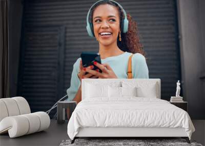 Black woman, smile and phone for social media in the city with headphones in joy for 5G connection in the outdoors. Happy African female student smiling for technology or internet on smartphone Wall mural