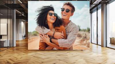 Couple, happy and smile hug in nature on a travel, adventure and road trip outdoor. Happiness of traveling girlfriend and boyfriend together in the summer sun with quality holiday time in the dessert Wall mural