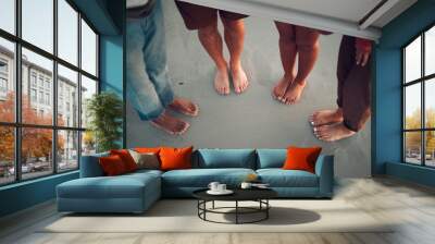 Friends, feet and beach in water, sand and travel summer vacation with diversity, men and women. People group relax on tropical sea holiday with wet toes together while traveling, friendship and trip Wall mural