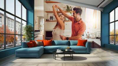 Joyful, dancing and loving couple bonding and having fun in the kitchen together at home. Energetic, fun and active relationship sharing a dance and romantic moment while enjoying their anniversary. Wall mural