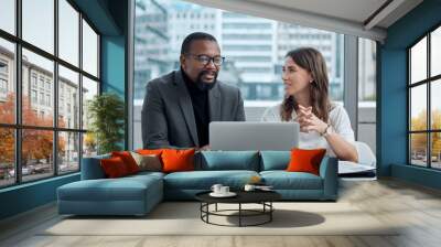 Learning from experience. Cropped shot of two corporate business colleagues having a meeting around the table in the boardroom. Wall mural