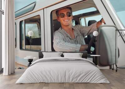 Travel, driving and adventure man in a caravan for outdoor nature journey, holiday in summer or vacation with sunglasses portrait. Young man in a van or car transport for a drive in countryside life Wall mural