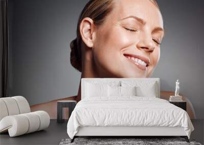 Smile, eyes closed and skincare of mature woman in studio for glow, results or beauty on gray background. Face, happy and model in natural cosmetics for dermatology, anti aging and aesthetic at spa Wall mural