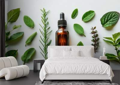 Dark colored transparent glass bottle and fresh leaves on white background. Herbal aromatherapy beauty treatments natural face and body care. Wall mural