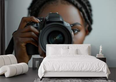 young afro american woman taking pictures with a large SLR camera in the studio on a white background Wall mural