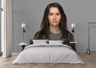 Portrait of a young woman in a white T-shirt. No make up, neutral Wall mural