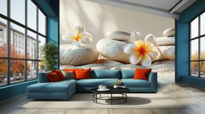 A relaxing spa setup with a white towel, smooth stones, and frangipani flowers, providing space for copy Wall mural