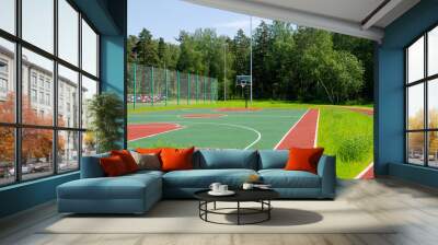 Empty street basketball court in the park on the sunny summer day. Wall mural