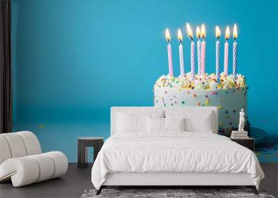 Birthday cake with candles and confetti on a blue background Wall mural