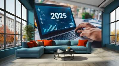 New year, business plan, and goals concept with a businessman's hand using a laptop computer, working on an office table background with a virtual screen display showing the text 