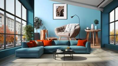 wooden table near black sofa on light blue wall with poster frame. generative ai Wall mural