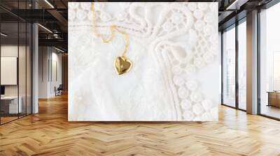 Gold heart necklace on lace Wall mural