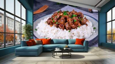 Stewed chicken gizzards on the boiled rice. Hot meal with offal meat products Wall mural