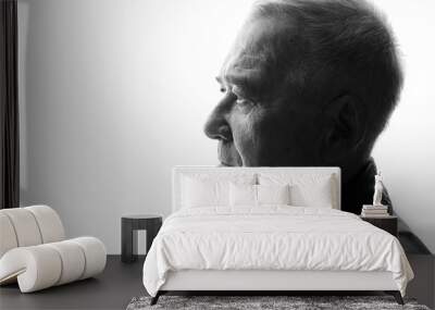 Black and white portrait of old man on white background. Aged male in profile. Free space for text. Wall mural