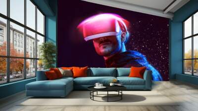 Model young man with beard in glasses of virtual reality on dark background. Augmented reality, future technology concept. VR. Neon light. Wall mural