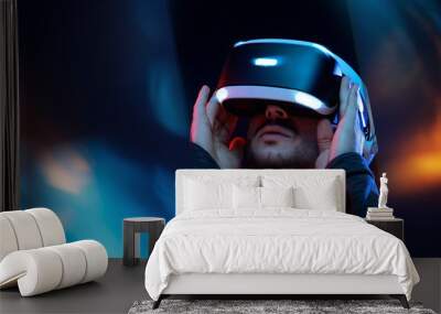 Model young man with beard in glasses of virtual reality. Augmented reality,  future technology concept. VR. Neon light. Wall mural