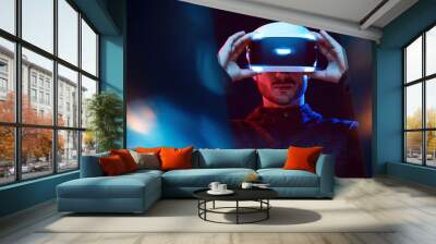 Model young man with beard in glasses of virtual reality. Augmented reality,  future technology concept. VR. Neon light. Wall mural