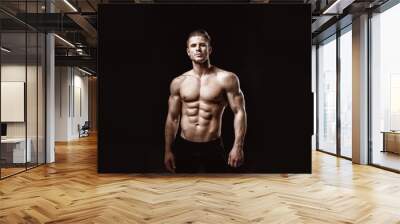 Muscular model young man on dark background. Fashion portrait of strong brutal guy with trendy hairstyle. Sexy naked torso, six pack abs. Male flexing his muscles. Sport workout bodybuilding concept. Wall mural