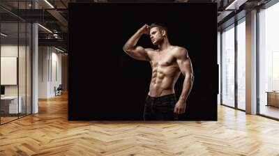 Muscular model young man on dark background. Fashion portrait of strong brutal guy with trendy hairstyle. Sexy naked torso, six pack abs. Male flexing his muscles. Sport workout bodybuilding concept. Wall mural