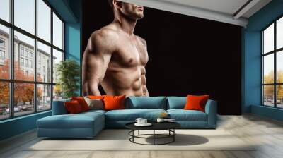 Muscular model young man on dark background. Fashion portrait of strong brutal guy with trendy hairstyle. Sexy naked torso, six pack abs. Male flexing his muscles. Sport workout bodybuilding concept. Wall mural