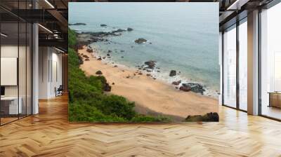 A cliff top view of Cola Beach in Goa on a cloudy day Wall mural