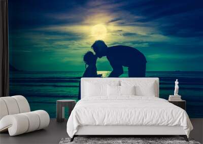 Father's day. Silhouette side view of loving child kissing her father. Wall mural