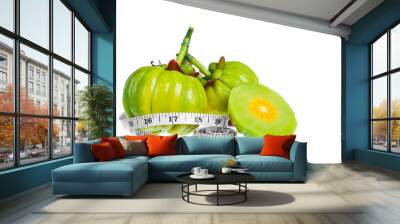 Garcinia cambogia fresh fruit with tapeline, isolated on white. Wall mural