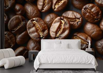 Aromatic backdrop of dark brown coffee bean halves in an overhead perspective Wall mural