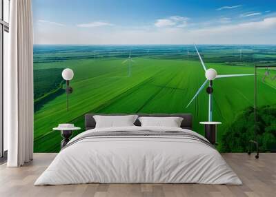 Breathtaking aerial perspective of wind turbines in a vibrant green landscape capturing renewable energy against a backdrop of serene blue skies Wall mural