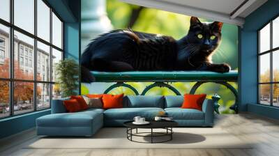 Charming black cat relaxing on elegant railing surrounded by lush greenery in park, capturing the essence of summer life for advertising designs Wall mural